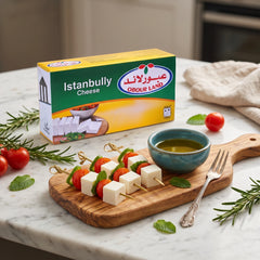 Creamy and tangy Obour Land Istanbully cheese in a 500g package, displayed with breakfast items on an elegant table setting.