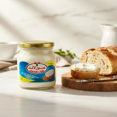 Obour Land 500g jar of spreadable processed cheese with creamy white texture, ideal for breakfast and snacks.